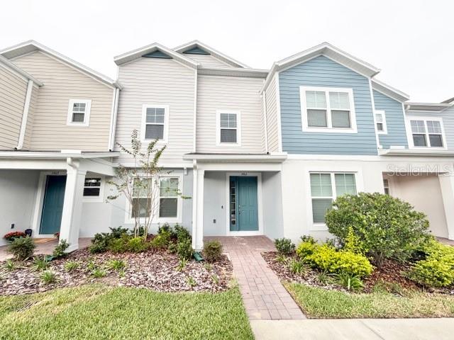 1463 Alston Bay Boulevard Apopka, FL 32703 - Photo 1 of 19 a front view of a house with a garden