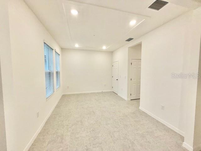 1463 Alston Bay Boulevard Apopka, FL 32703 - Photo 2 of 19 an empty room with a empty space and windows