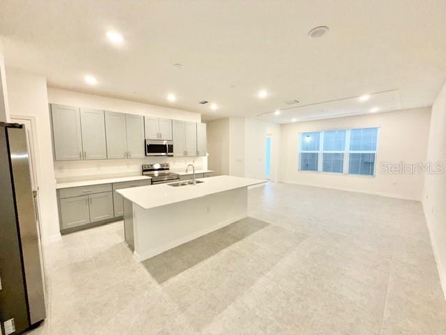 1463 Alston Bay Boulevard Apopka, FL 32703 - Photo 4 of 19 a large white kitchen with white cabinets