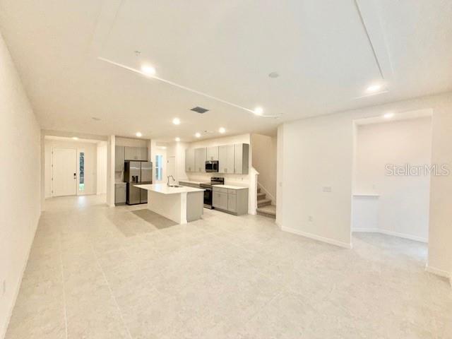 1463 Alston Bay Boulevard Apopka, FL 32703 - Photo 5 of 19 a view of kitchen with refrigerator and white cabinets
