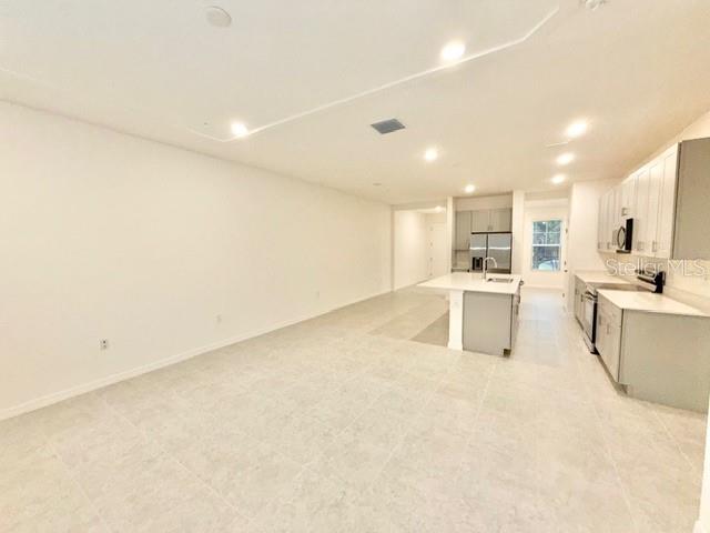 1463 Alston Bay Boulevard Apopka, FL 32703 - Photo 6 of 19 a view of kitchen with white cabinets and sink