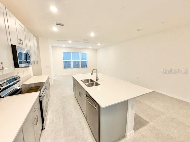 1463 Alston Bay Boulevard Apopka, FL 32703 - Photo 7 of 19 a kitchen with a sink a stove and a refrigerator