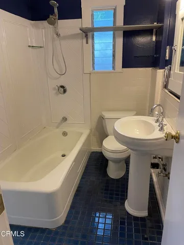 a bathroom with a sink a toilet and a bathtub