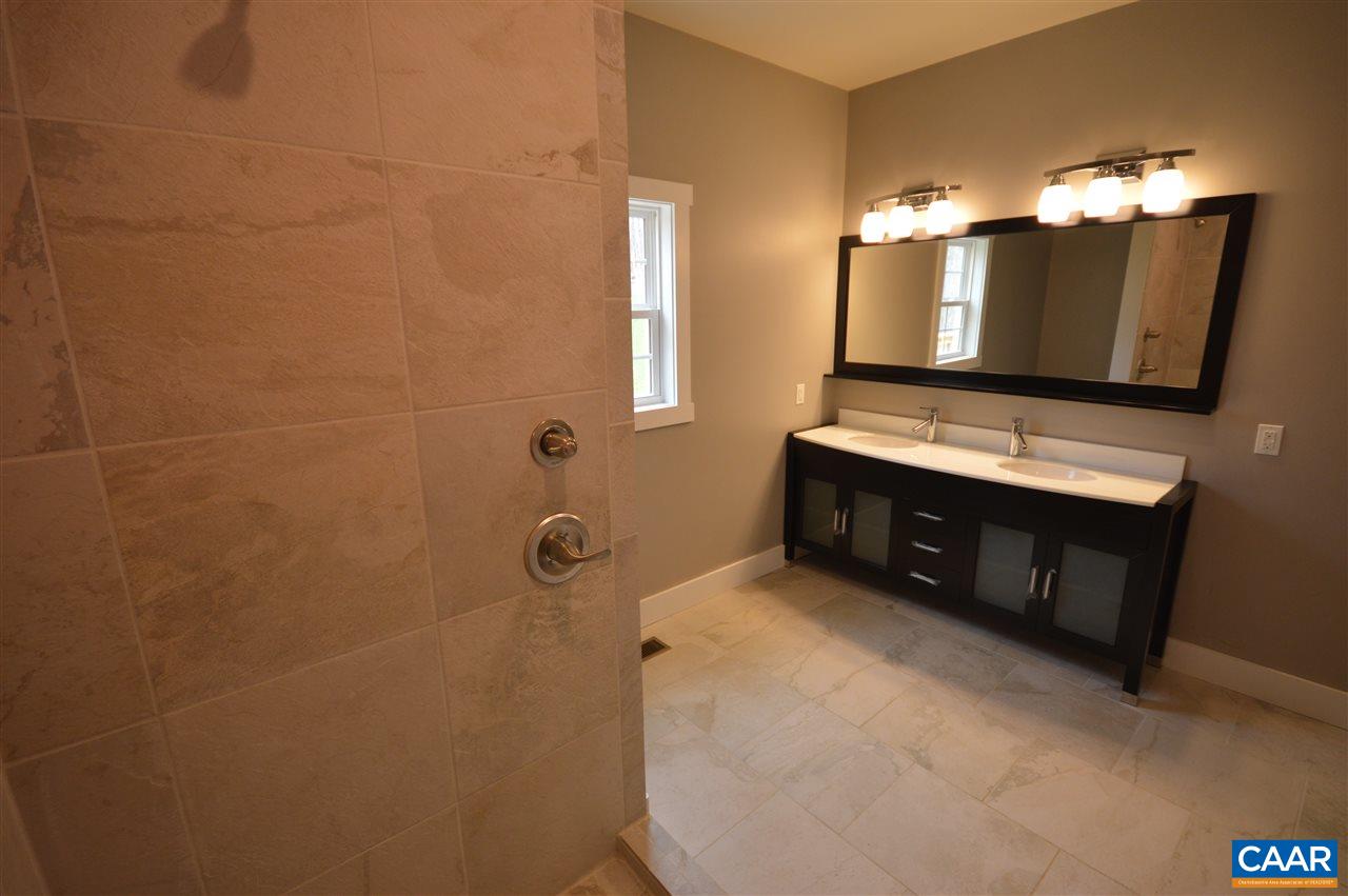 2501 Dunnes Shop Road Ruckersville, VA 22968 - Photo 18 of 46 a bathroom with a tub sink and mirror