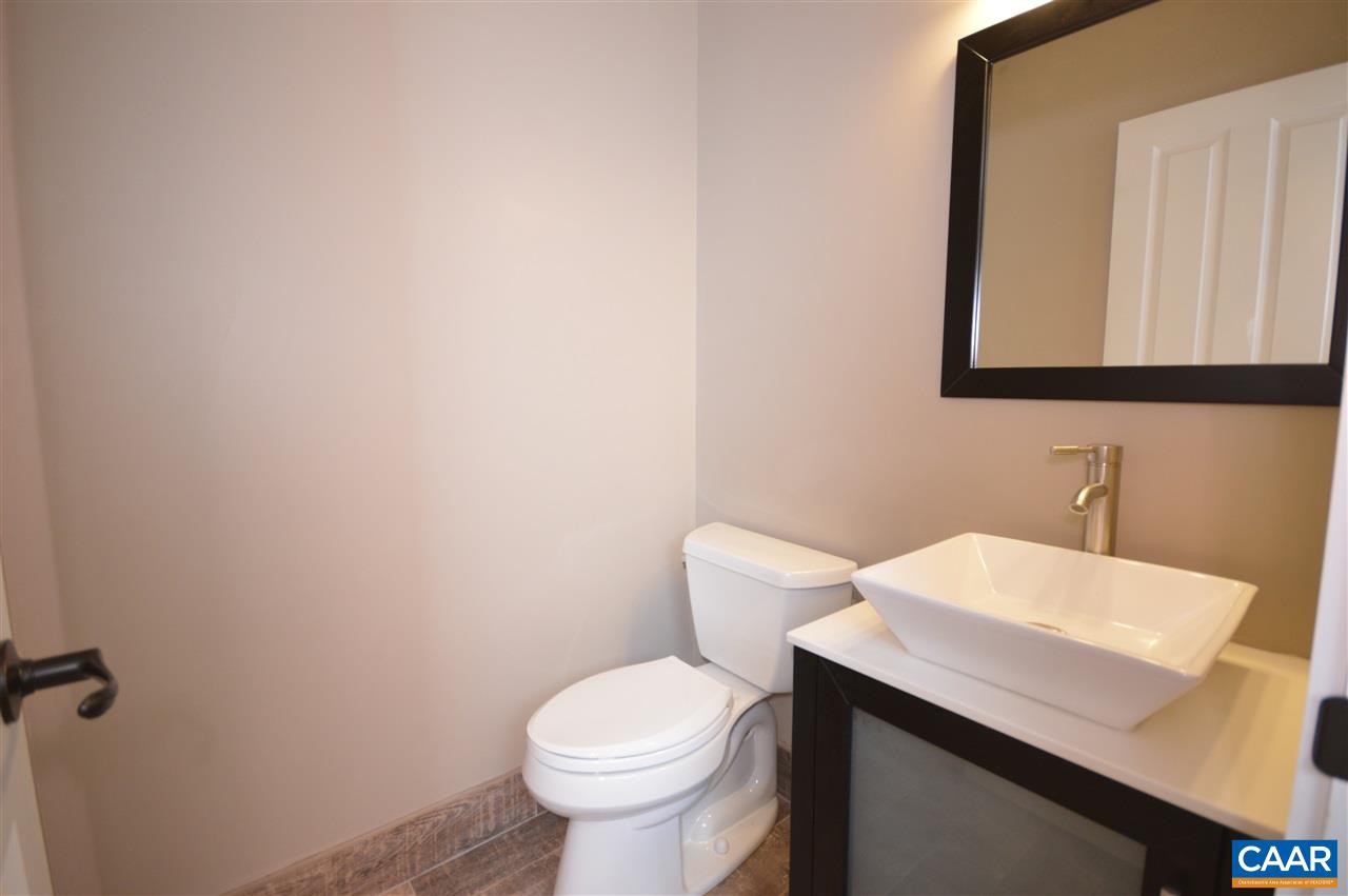 2501 Dunnes Shop Road Ruckersville, VA 22968 - Photo 26 of 46 a bathroom with a sink a toilet and mirror