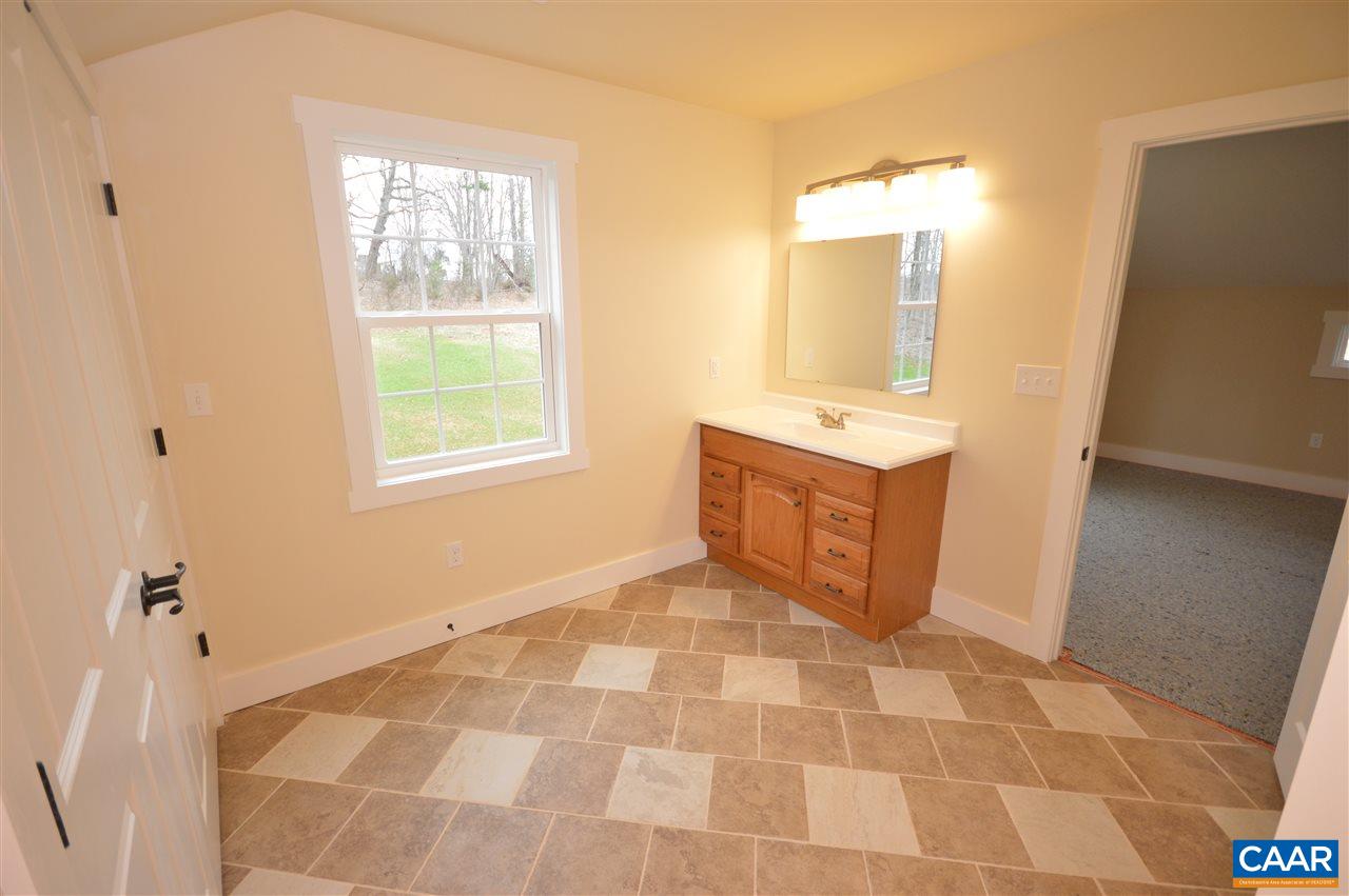 2501 Dunnes Shop Road Ruckersville, VA 22968 - Photo 28 of 46 a bathroom with a sink toilet and mirror