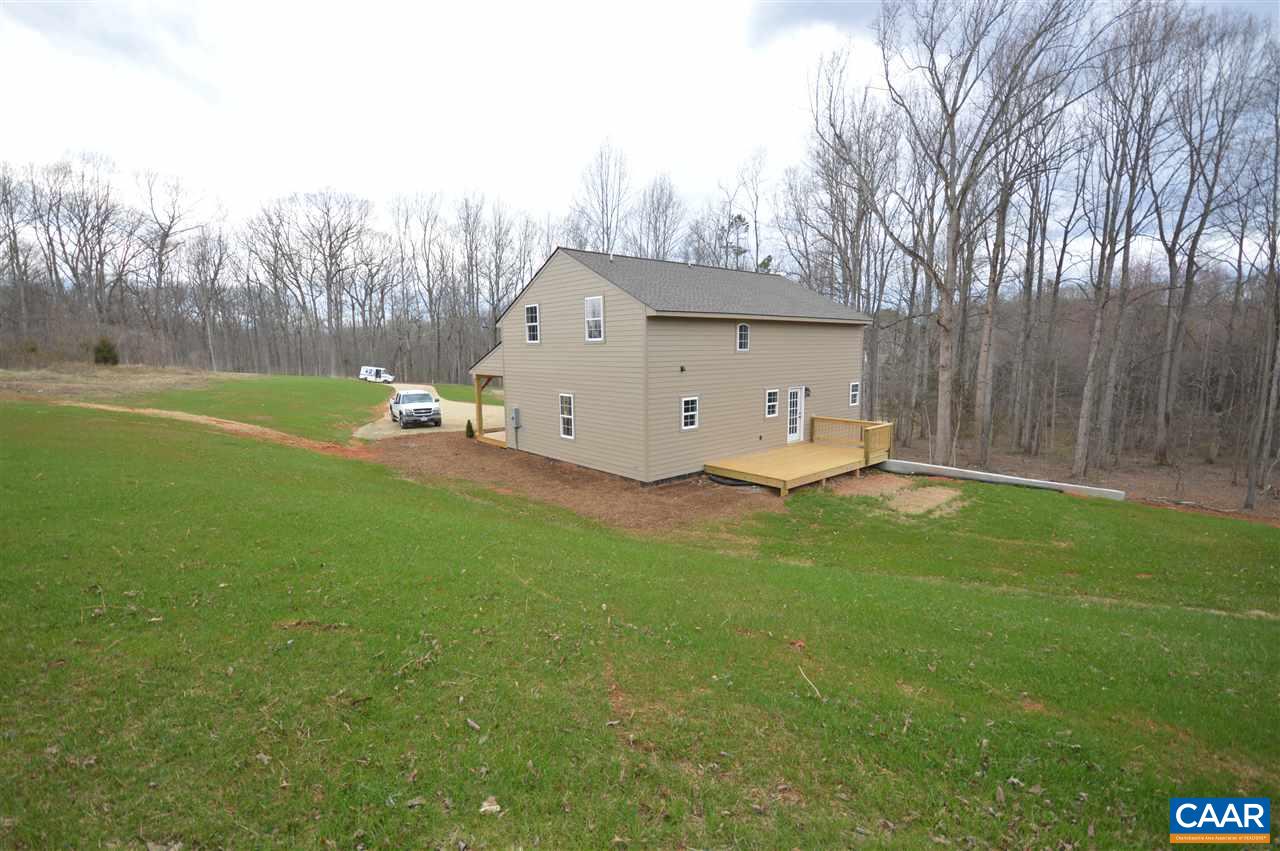 2501 Dunnes Shop Road Ruckersville, VA 22968 - Photo 35 of 46 a view of a backyard with a small cabin and a chair