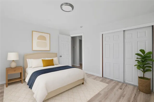 a bedroom with a bed and a potted plant