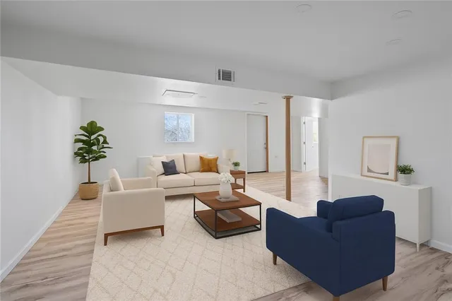 a living room with furniture and a potted plant