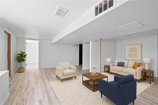 a living room with furniture and a potted plant