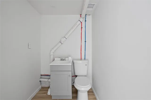 a bathroom with a sink toilet and a mirror