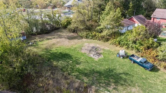 an aerial view of residential house with space and trees all around