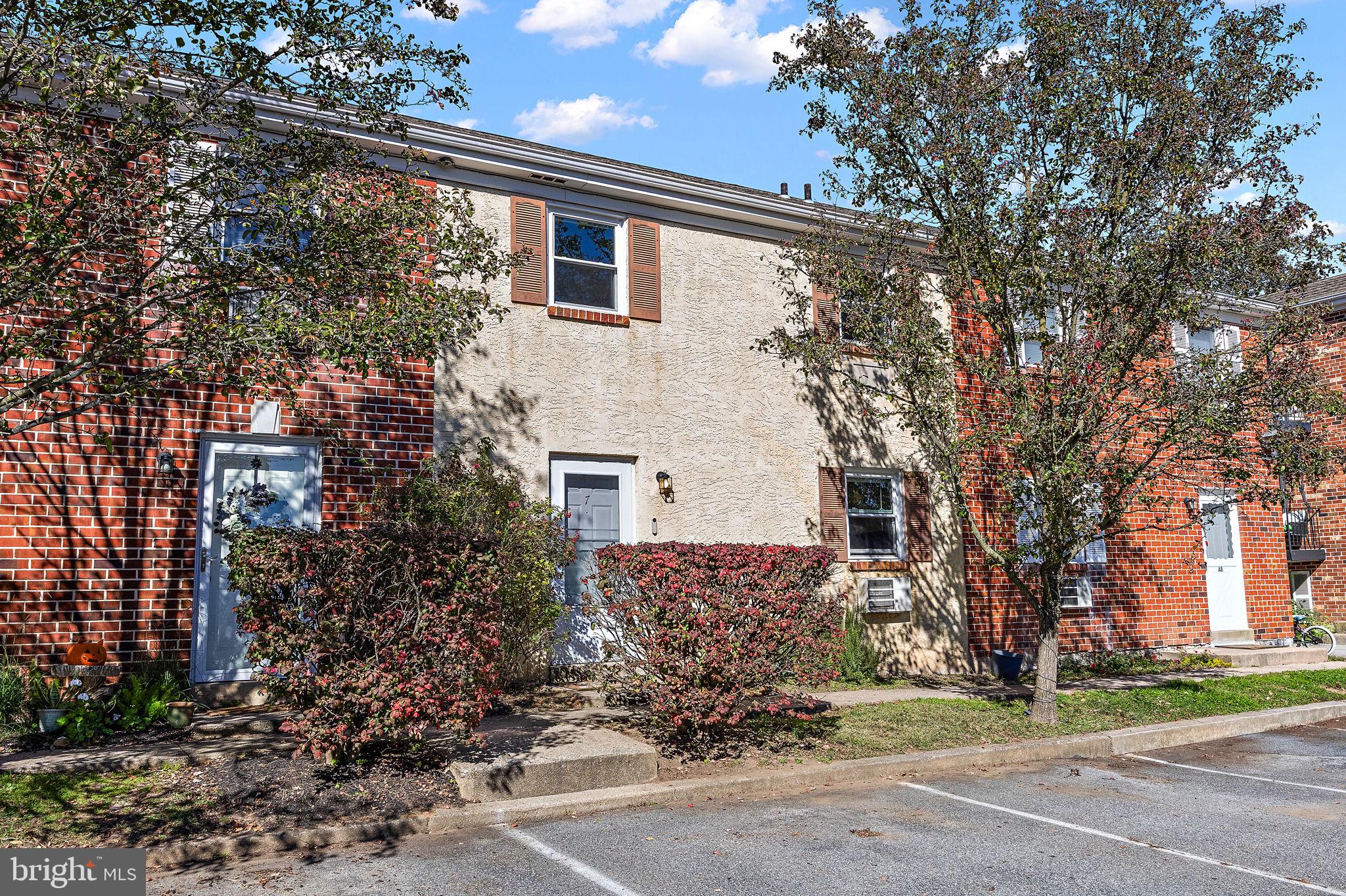117 Railroad Avenue, Unit A7 West Grove, PA 19390 - Photo 1 of 27 a front view of a house with a yard and garage