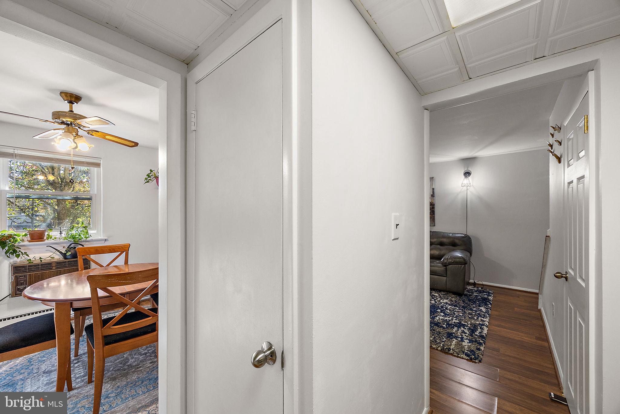117 Railroad Avenue, Unit A7 West Grove, PA 19390 - Photo 12 of 27 a view of a hallway with wooden floor and a livingroom