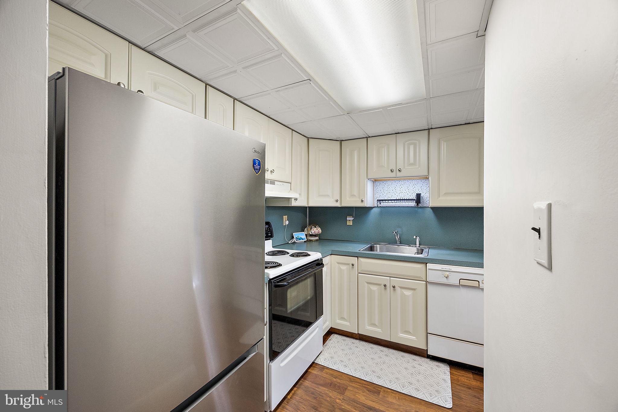 117 Railroad Avenue, Unit A7 West Grove, PA 19390 - Photo 13 of 27 a kitchen with a white cabinets and white appliances
