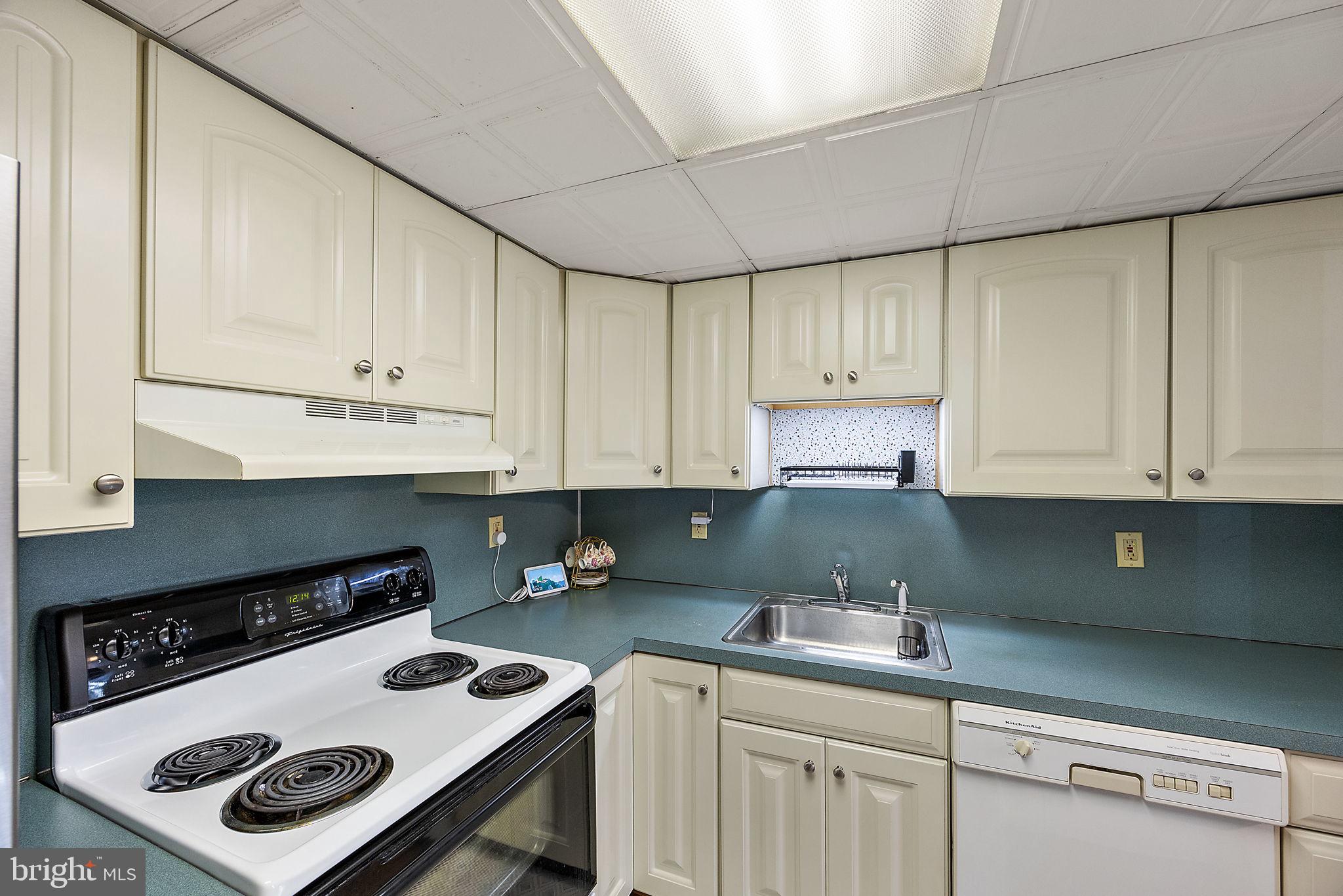 117 Railroad Avenue, Unit A7 West Grove, PA 19390 - Photo 14 of 27 a kitchen with a cabinets and white appliances