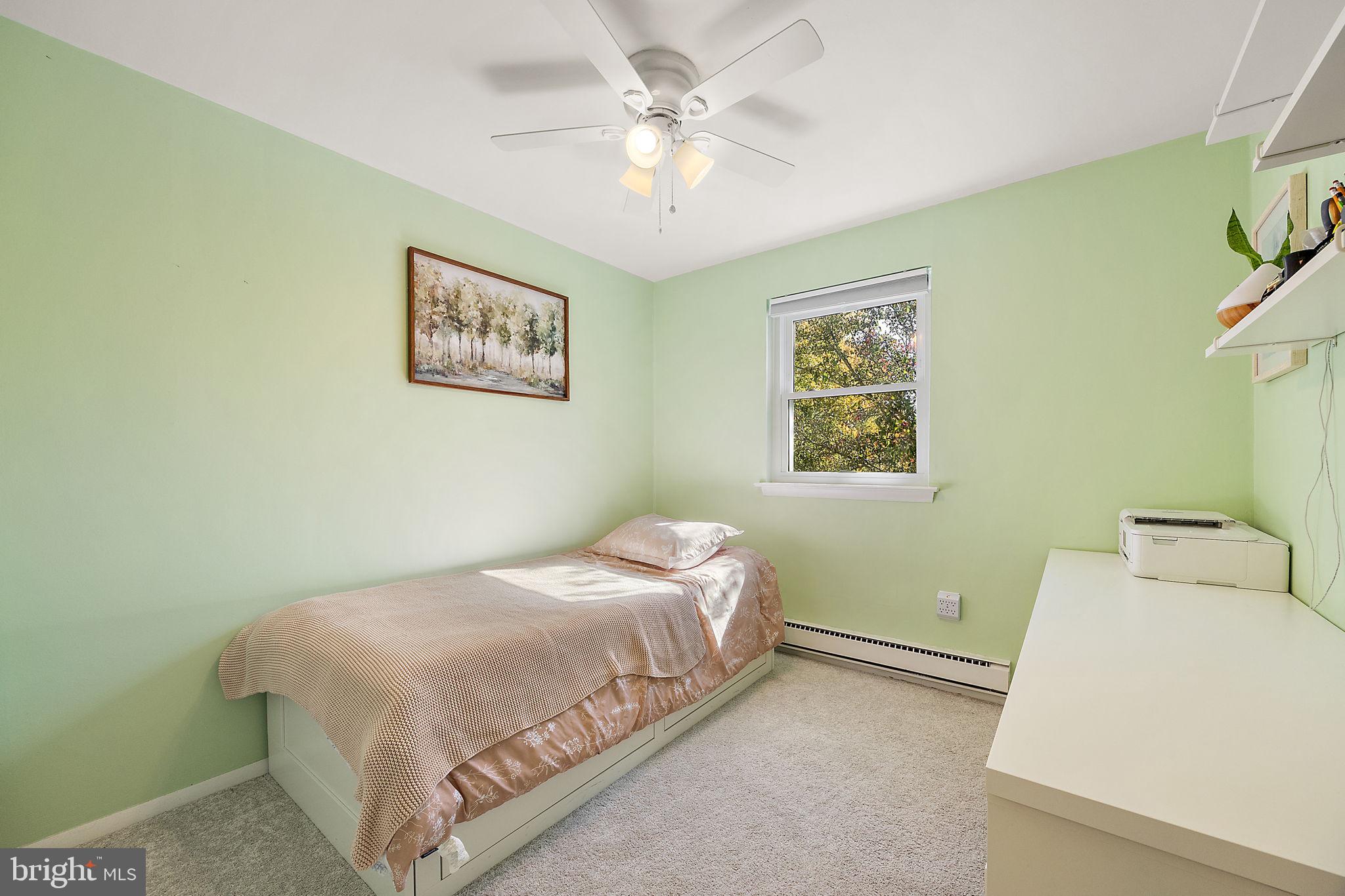 117 Railroad Avenue, Unit A7 West Grove, PA 19390 - Photo 17 of 27 a bedroom with a bed and a painting on the wall