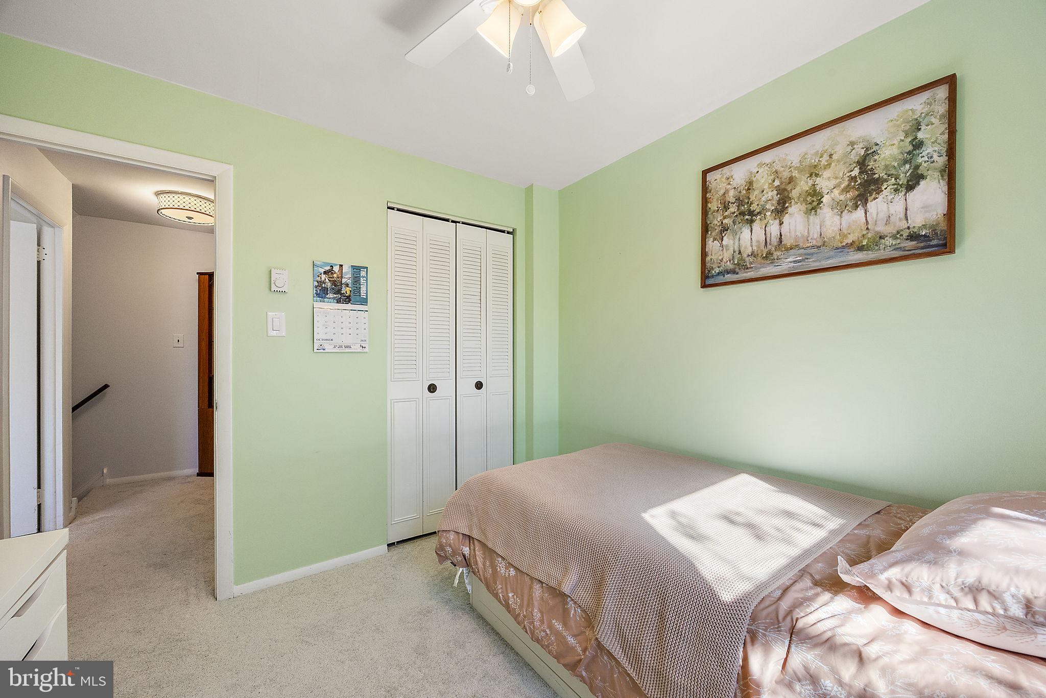 117 Railroad Avenue, Unit A7 West Grove, PA 19390 - Photo 18 of 27 a bedroom with a bed and a painting on the wall