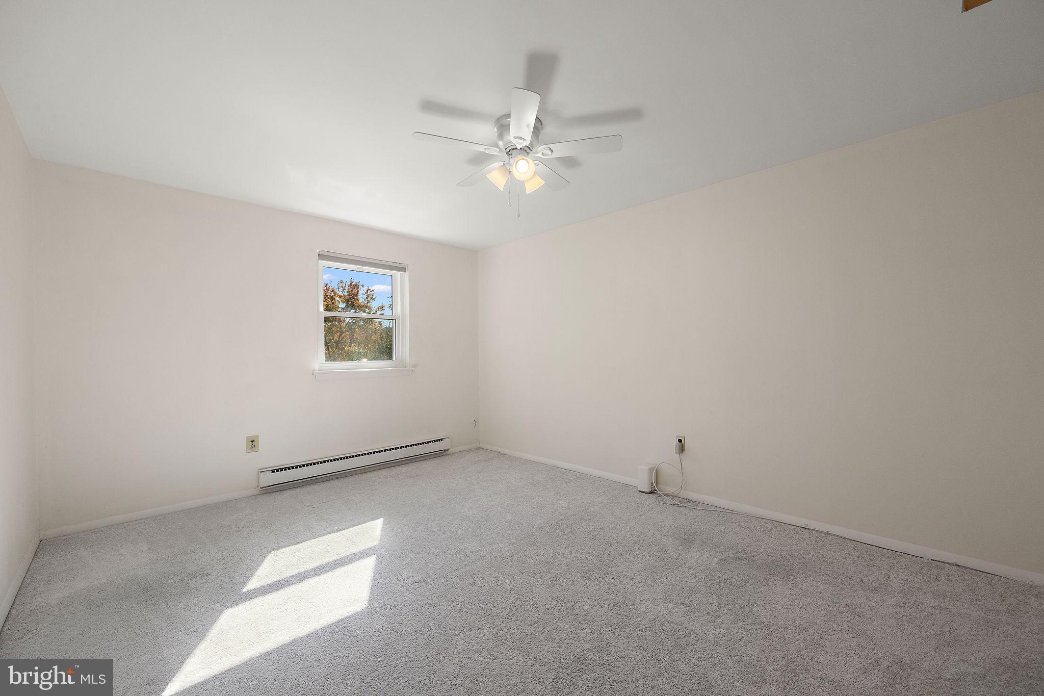 117 Railroad Avenue, Unit A7 West Grove, PA 19390 - Photo 20 of 27 an empty room with a window and a fan