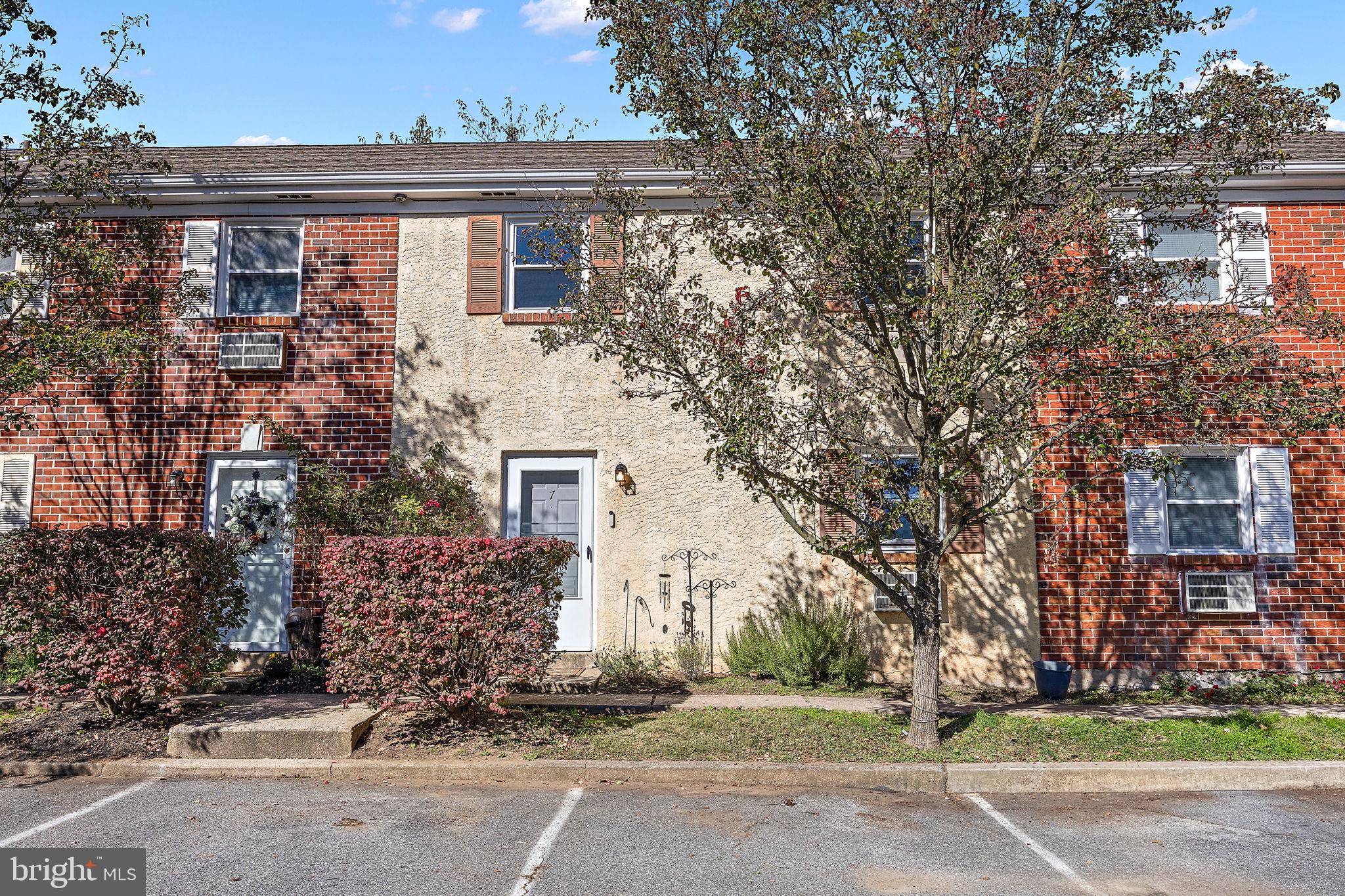 117 Railroad Avenue, Unit A7 West Grove, PA 19390 - Photo 2 of 27 a front view of a house with a yard and garage