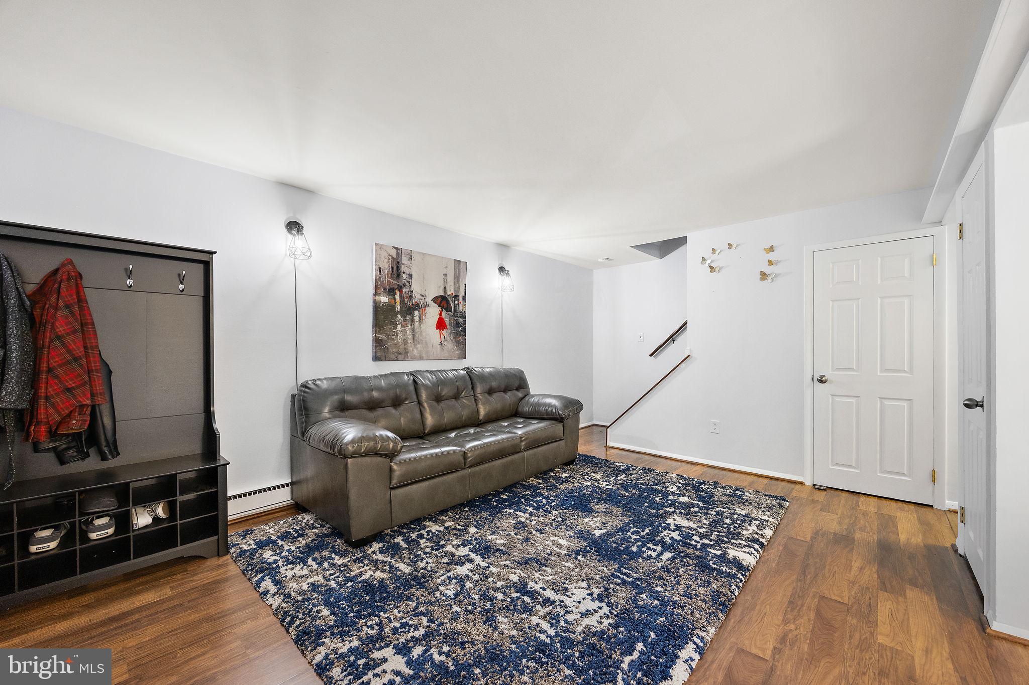 117 Railroad Avenue, Unit A7 West Grove, PA 19390 - Photo 5 of 27 a living room with furniture and a flat screen tv