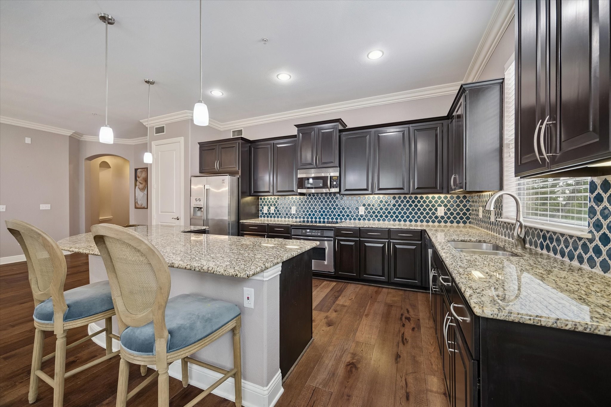 2120 Kipling Street, Unit 304 Houston, TX 77098 - Photo 7 of 24 The well-designed kitchen combines style and practicality with sleek stainless steel appliances, granite countertops, and abundant cabinet storage. A spacious breakfast bar island provides the ideal setting for casual meals and conversation.
