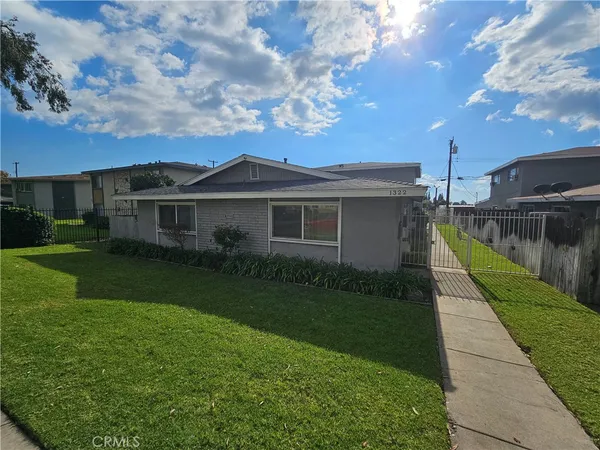 a view of a house with a backyard