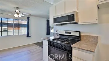 a kitchen with stainless steel appliances granite countertop a stove and a microwave