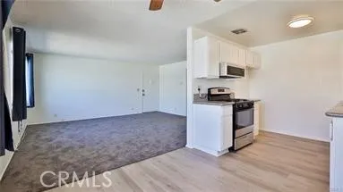 a kitchen with granite countertop a sink and a stove top oven