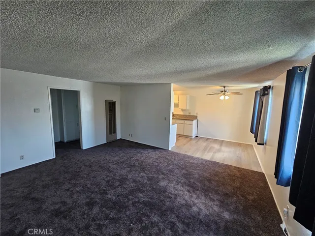 a view of a big room with a fireplace and painted walls