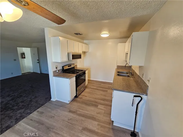 a kitchen with granite countertop a stove and a refrigerator