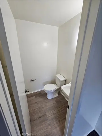 a bathroom with a sink a toilet a mirror and vanity