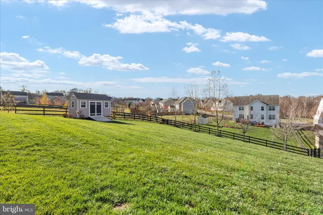 a view of a big house with a big yard and a large tree