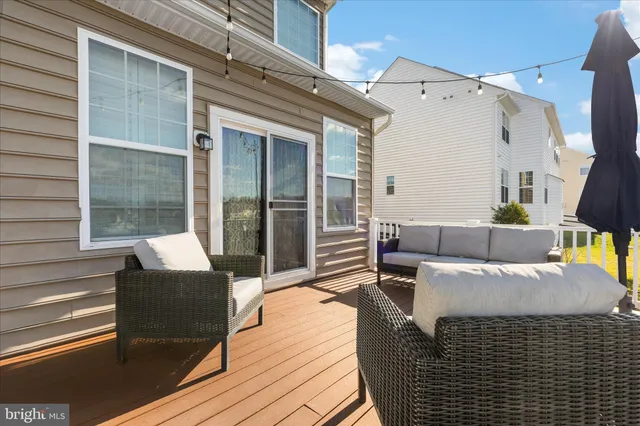 a balcony with couches and wooden floor