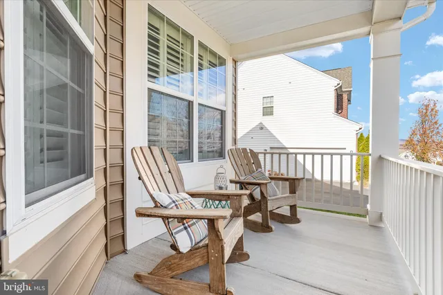 a balcony with table and chairs