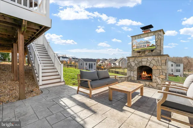 a building outdoor space with patio furniture and a fireplace