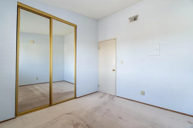 an empty room with sliding glass door