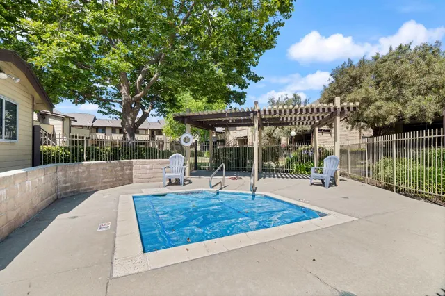 a view of a house with swimming pool and porch with furniture
