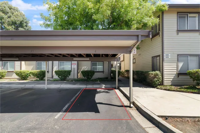 a view of a patio with a bench and plants