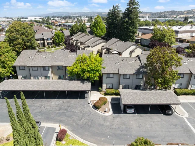 an aerial view of a house with swimming pool and sitting area