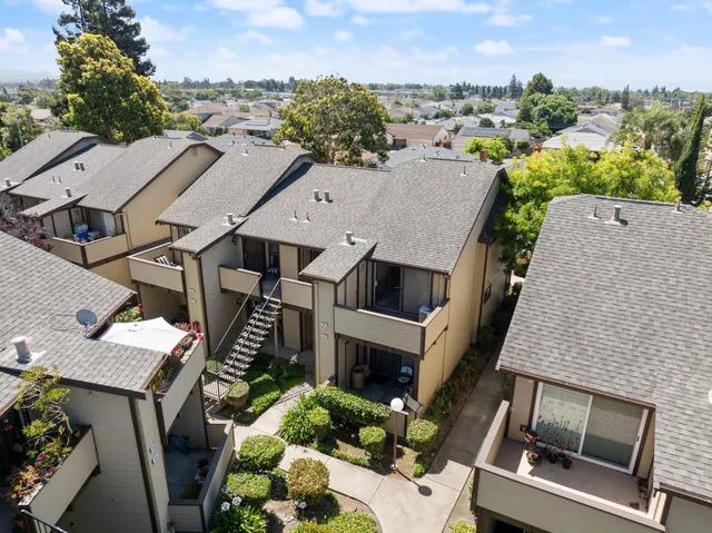 an aerial view of residential houses with outdoor space