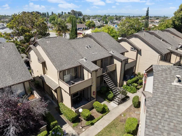 an aerial view of a house with a yard