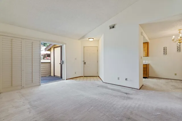 an empty room with windows and closet