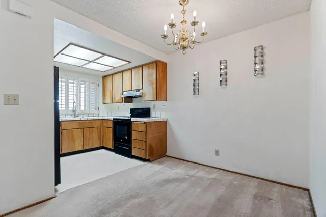 a kitchen with a refrigerator and a sink
