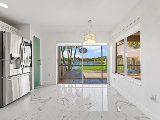 a kitchen with granite countertop a stove a sink and a microwave