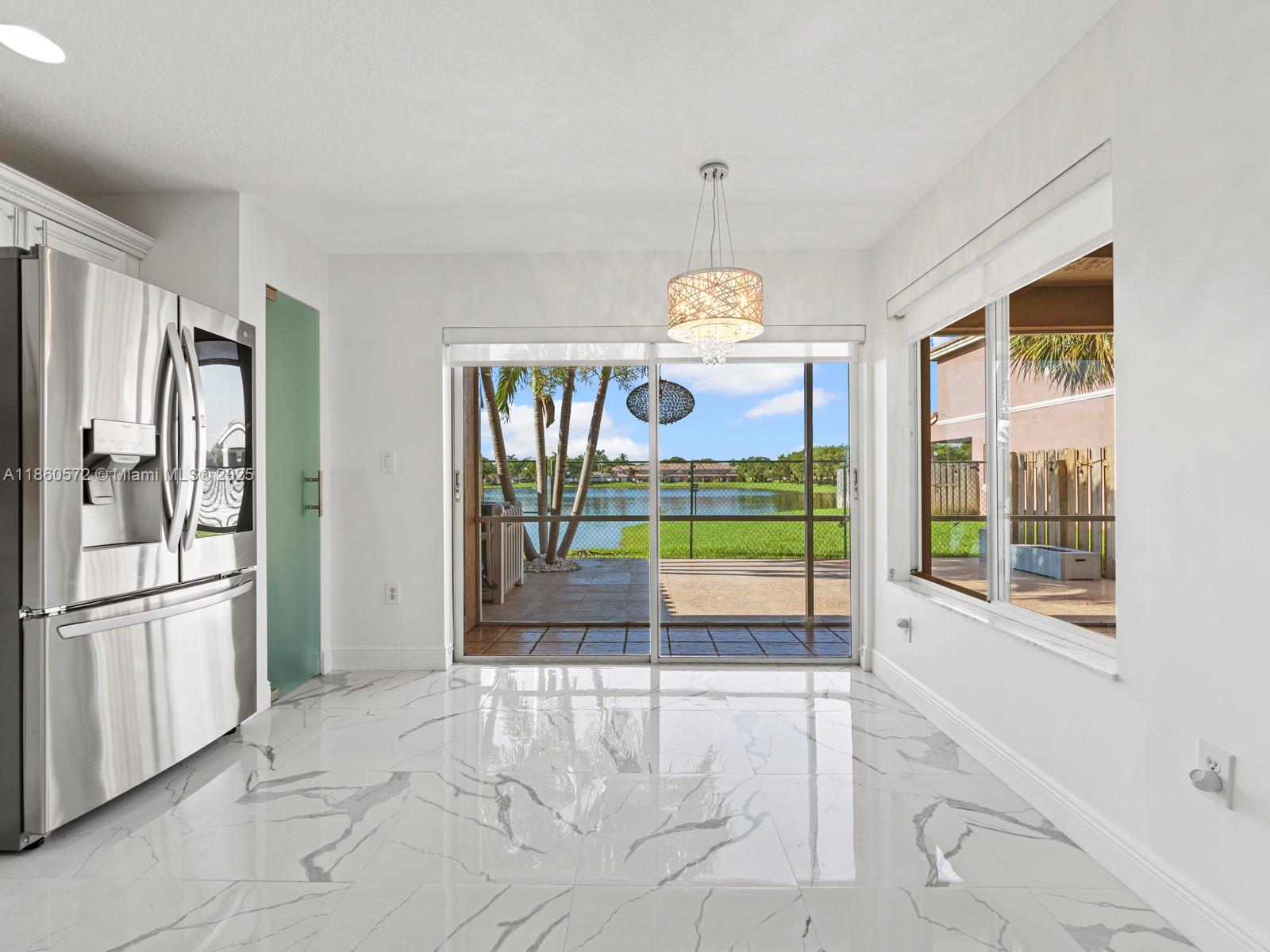 16544 Southwest 68th Terrace Miami, FL 33193 - Photo 12 of 32 a view of an empty room and window