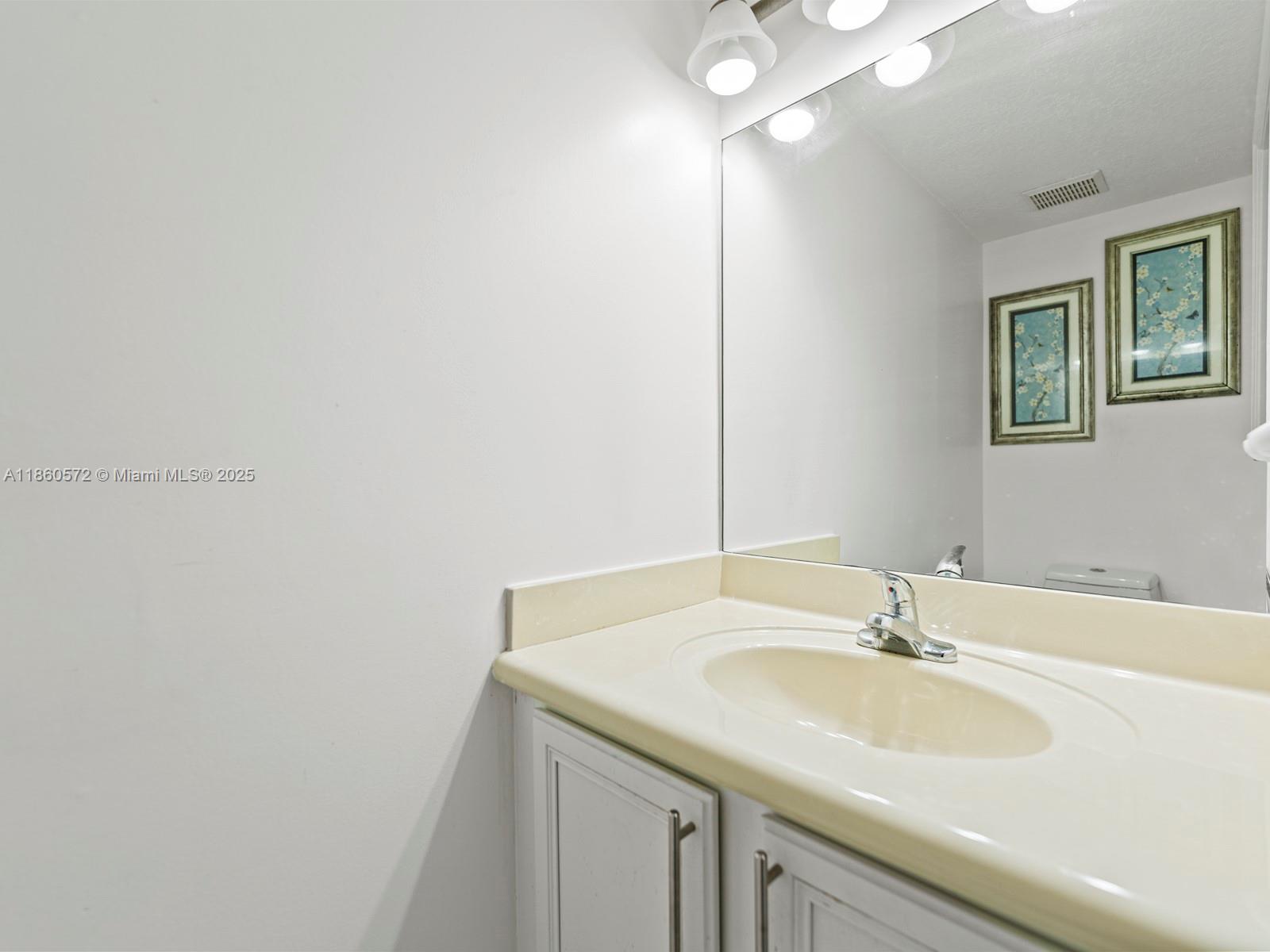 16544 Southwest 68th Terrace Miami, FL 33193 - Photo 16 of 32 a bathroom with a sink and a mirror