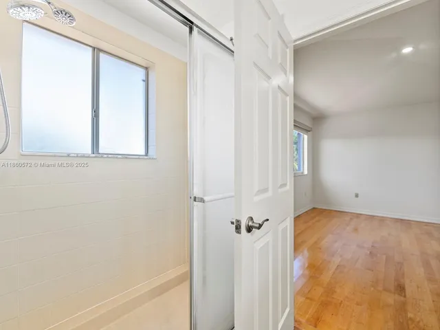 a view of empty room with wooden floor