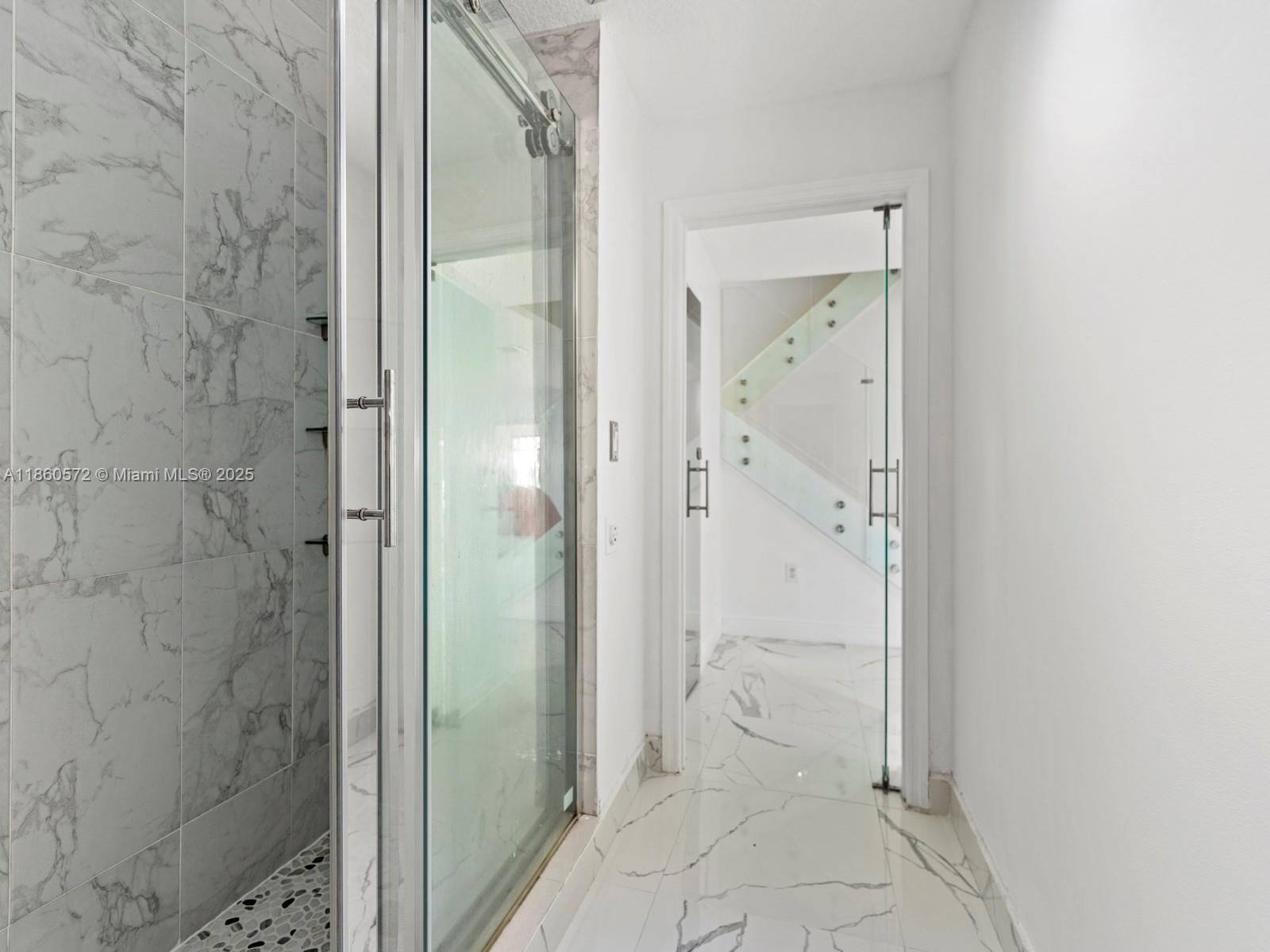 16544 Southwest 68th Terrace Miami, FL 33193 - Photo 22 of 32 a bathroom with a glass shower door
