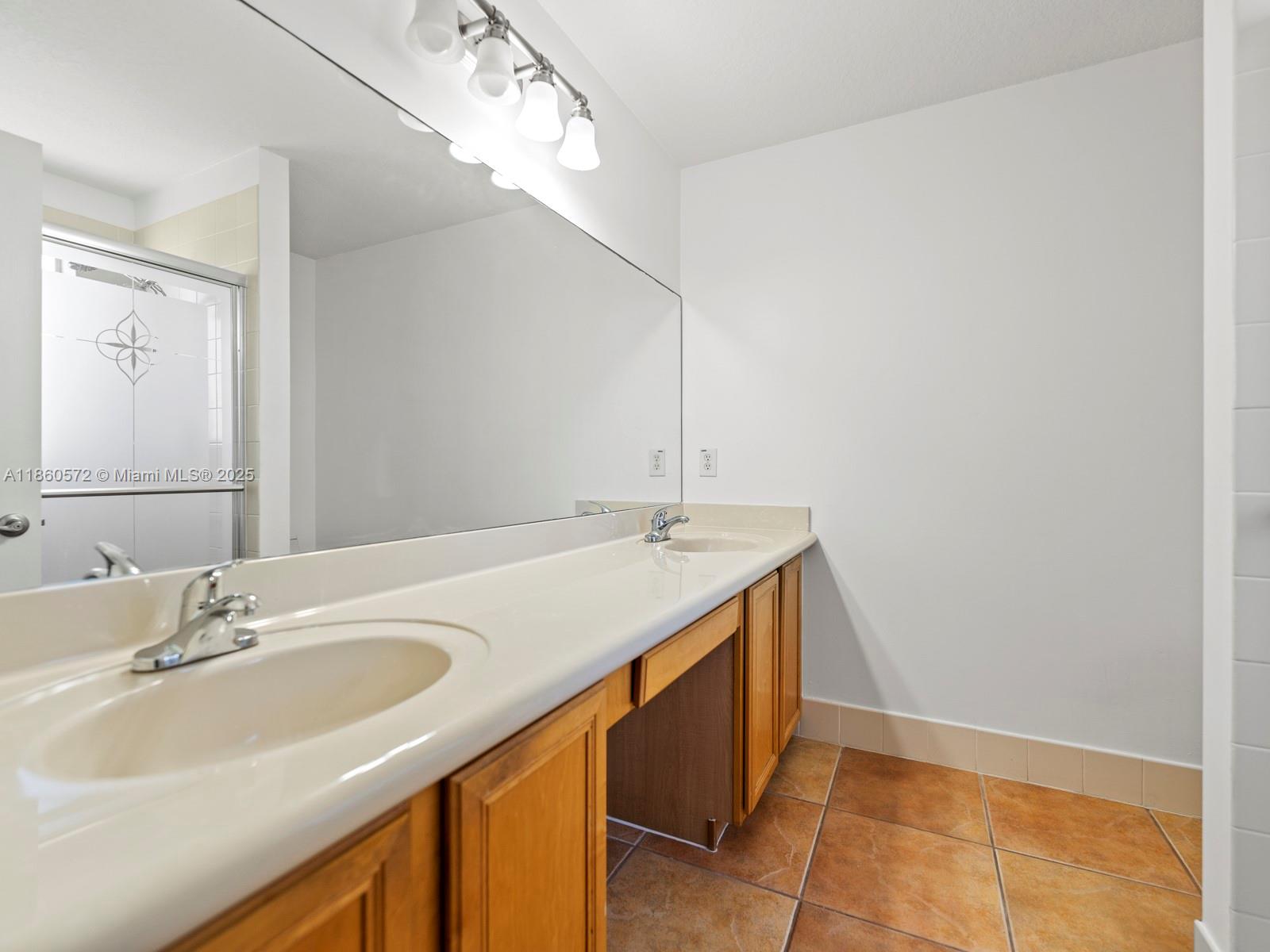 16544 Southwest 68th Terrace Miami, FL 33193 - Photo 30 of 32 a bathroom with a sink and a mirror
